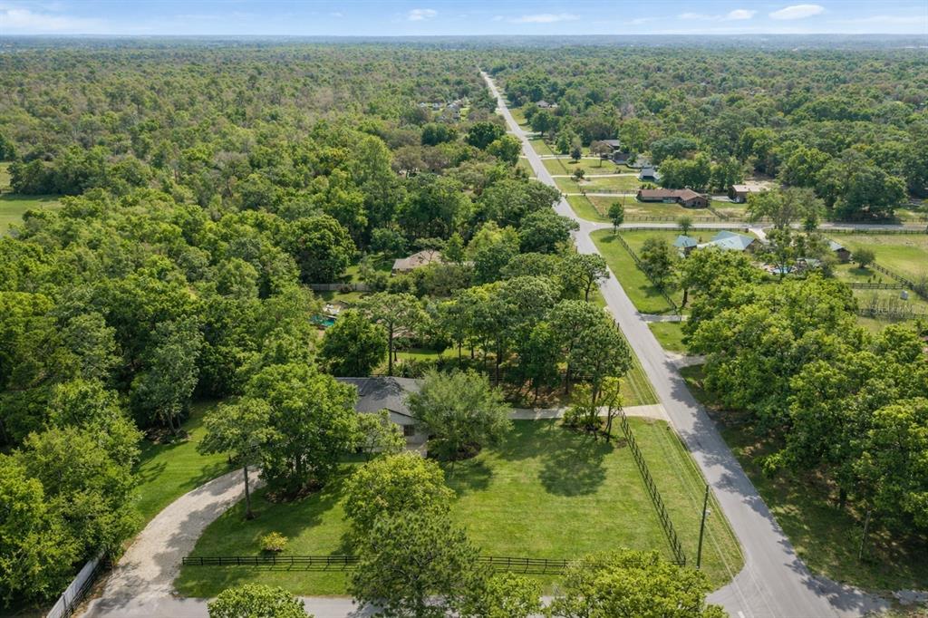 5721 Southwest 31st Street Ocala, FL 34474 - Photo 39 of 41 an aerial view of residential houses with outdoor space and trees
