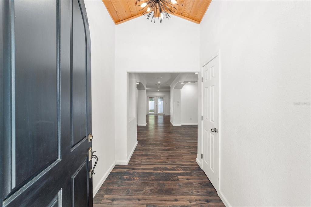 5721 Southwest 31st Street Ocala, FL 34474 - Photo 5 of 41 a view of a hallway with wooden floor and staircase
