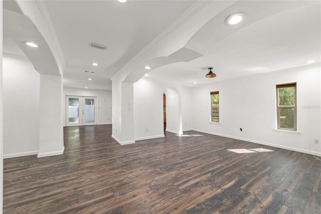 5721 Southwest 31st Street Ocala, FL 34474 - Photo 7 of 41 a view of an empty room with wooden floor and a window