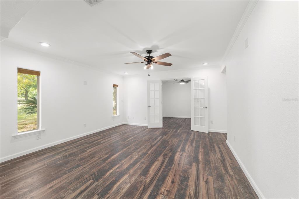 5721 Southwest 31st Street Ocala, FL 34474 - Photo 10 of 41 wooden floor in an empty room with a window