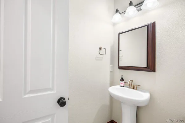 a bathroom with a sink mirror and vanity