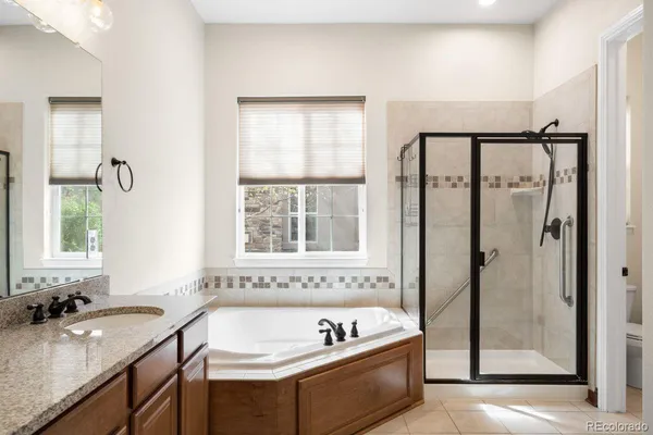 a bathroom with a tub a sink and a window