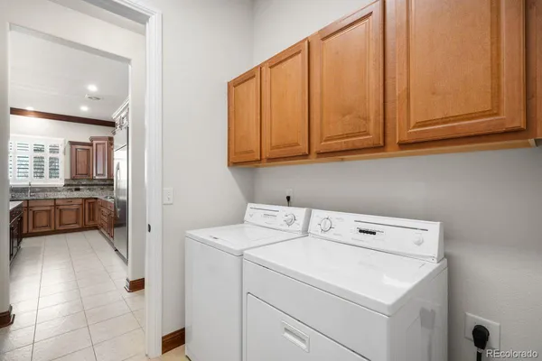 a view of washer and dryer with bathroom in the background