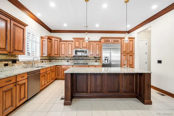 a kitchen with a sink counter top space appliances and cabinets