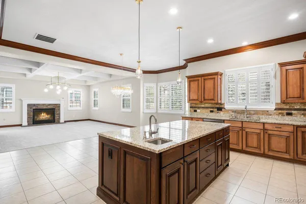 a spacious kitchen with stainless steel appliances granite countertop a sink and a stove