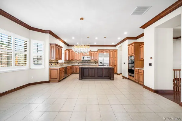 a view of kitchen with stainless steel appliances a sink and counter top space