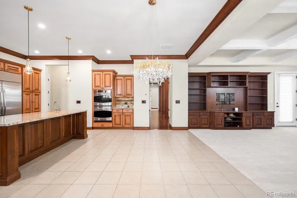 a view of a kitchen with refrigerator and window