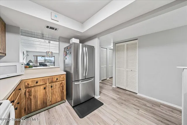 a kitchen with stainless steel appliances a refrigerator and a stove top oven