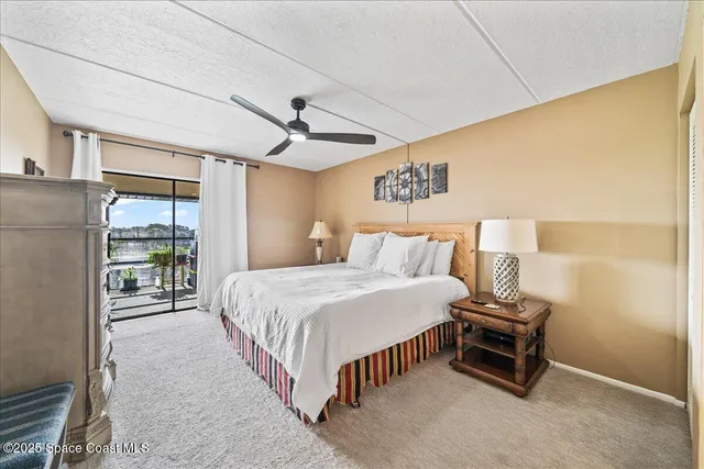 a bedroom with a bed and a ceiling fan