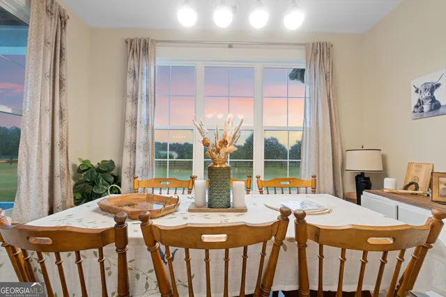 a view of a dining room with furniture window and outside view