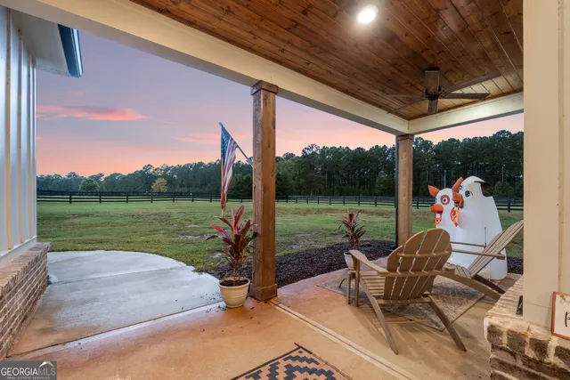 a view of a patio with a table chairs and a backyard