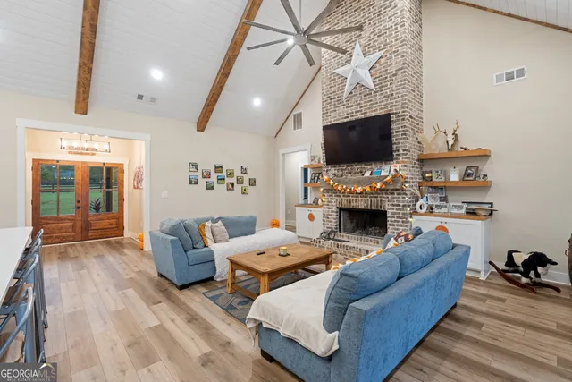 a living room with furniture a flat screen tv and a fireplace
