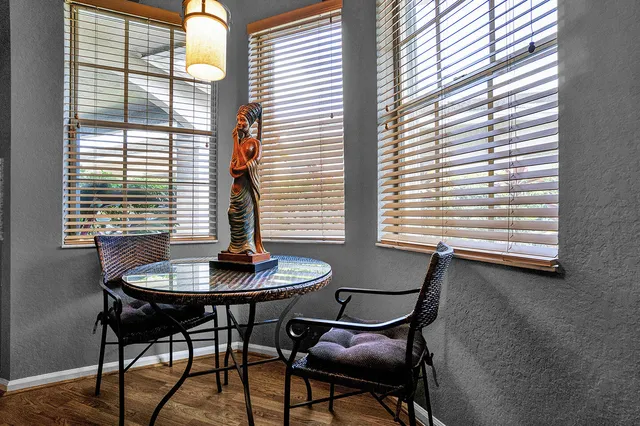 a view of a dining room with furniture and windows