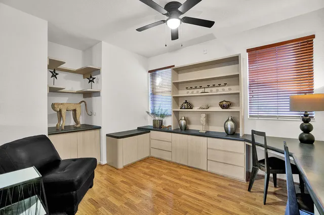 a kitchen with stainless steel appliances a sink a stove a refrigerator dining table and chairs