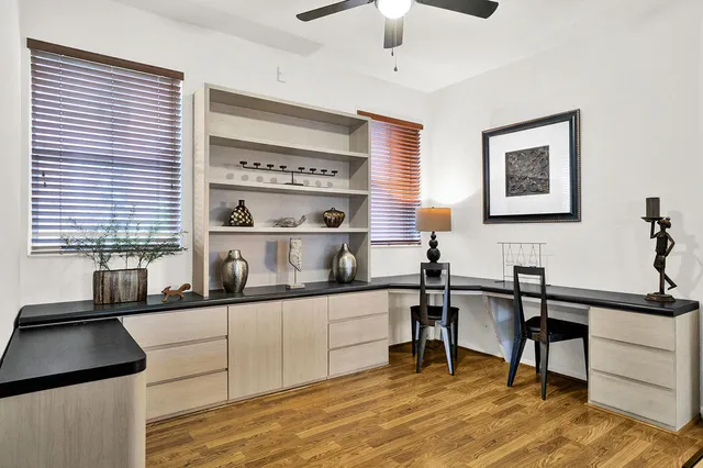 a kitchen with a sink a window and cabinets