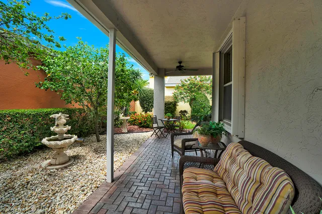 a view of a porch with chairs and backyard