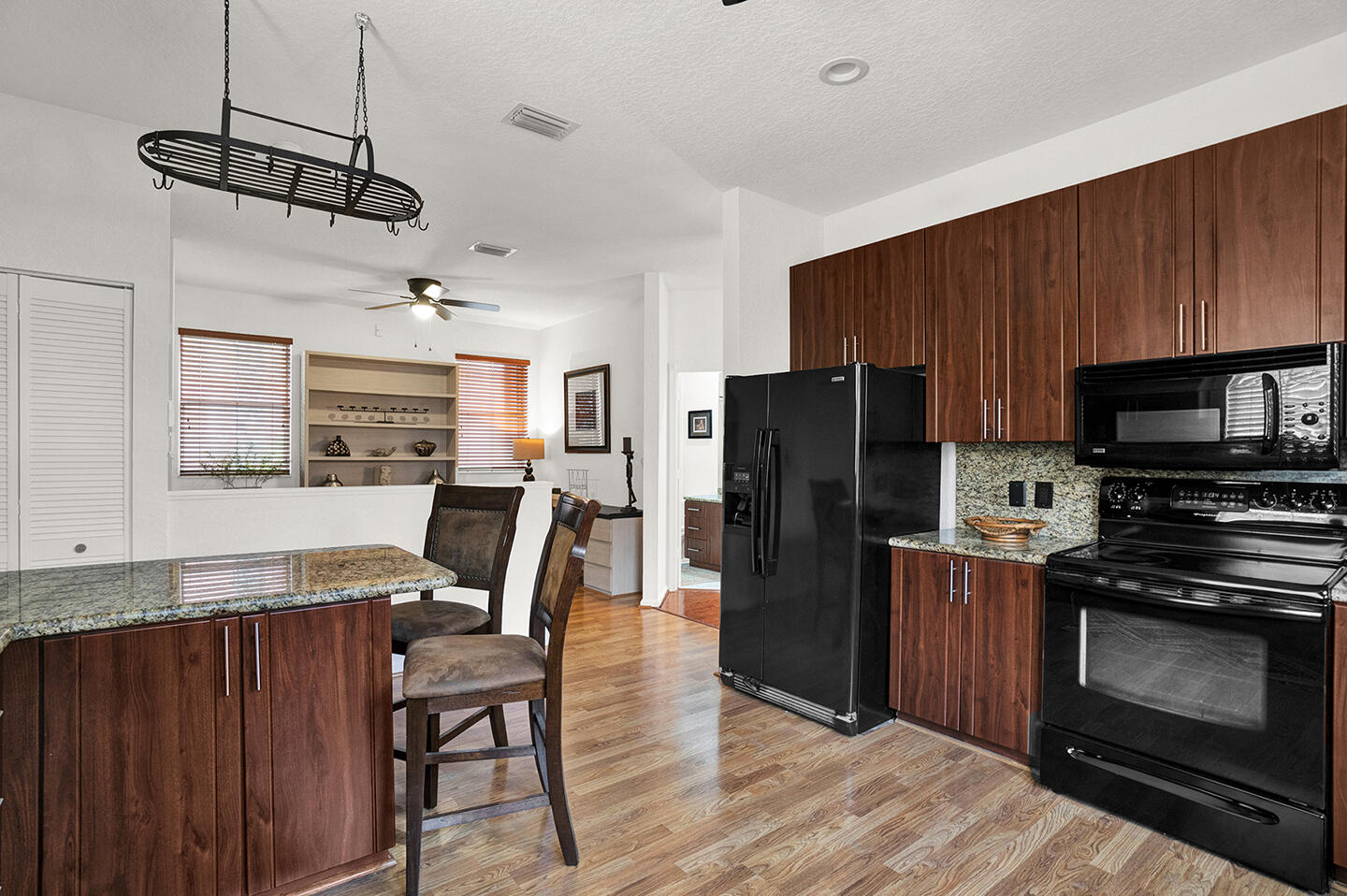 22831 Windsor Wood Court Boca Raton, FL 33433 - Photo 9 of 48 a kitchen with stainless steel appliances granite countertop a refrigerator a stove top oven a sink dishwasher and wooden cabinets