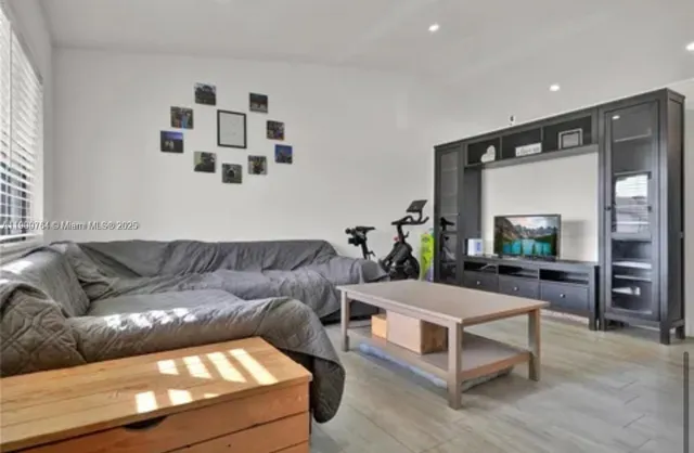 a living room with a couch and a flat screen tv