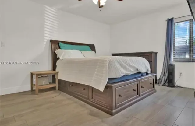 a bed sitting in a bedroom next to a window