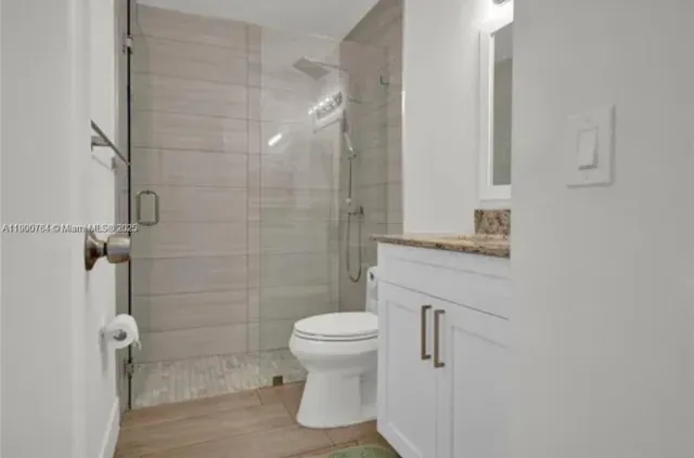 a bathroom with a toilet sink and shower