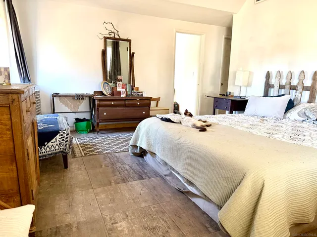 a bed sitting in a bedroom next to a window