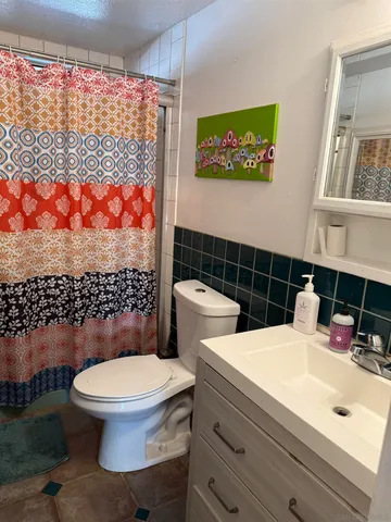 a bathroom with a toilet a sink and a shower