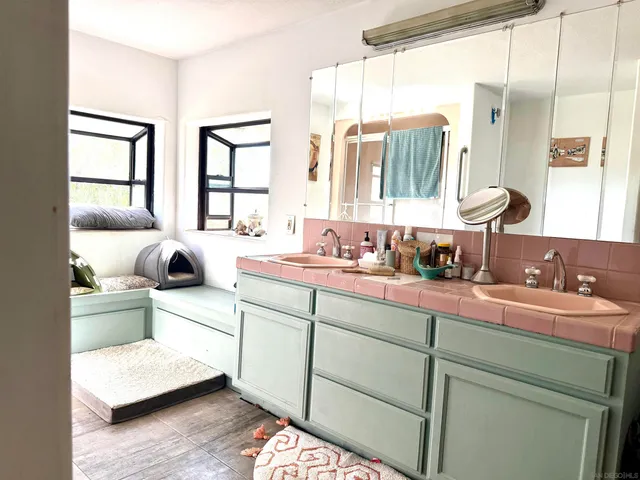 a large bedroom with a large bed and a window