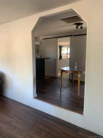 a view of livingroom and dining room with wooden floor