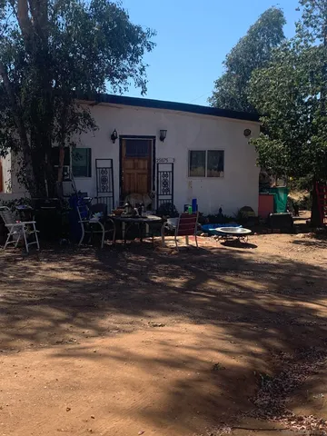 a backyard of a house with outdoor seating