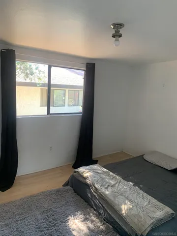 a bedroom with bed and window