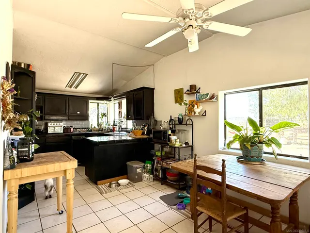 a kitchen with a table chairs and microwave