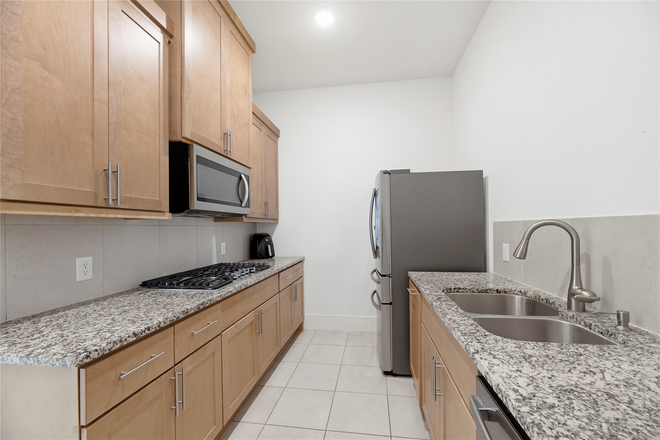 29526 Cir S Rnch Trail Fulshear, TX 77406 - Photo 15 of 48 a kitchen with stainless steel appliances granite countertop a sink a stove and a refrigerator with wooden cabinets
