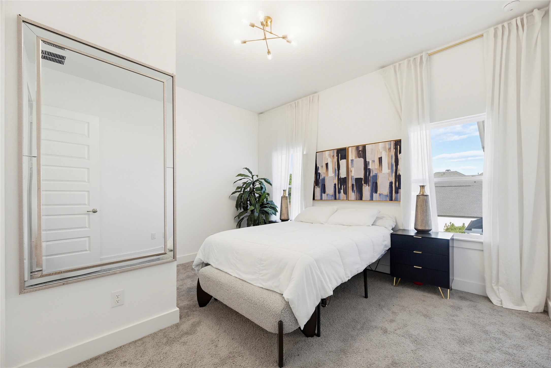 29526 Cir S Rnch Trail Fulshear, TX 77406 - Photo 27 of 48 a bedroom with a large bed and a potted plant