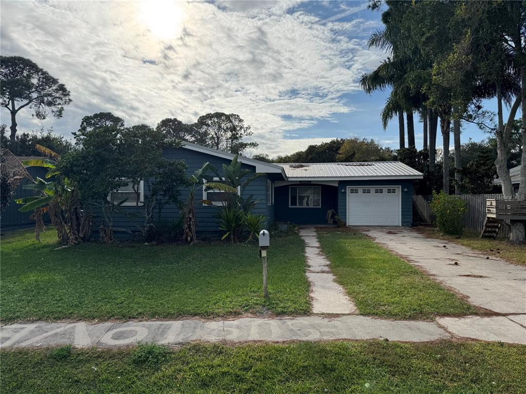 861 Palermo Road St. Augustine, FL 32086 - Photo 2 of 33 a front view of a house with a garden and trees