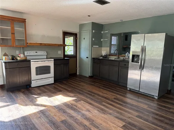 a kitchen with a refrigerator stove and sink