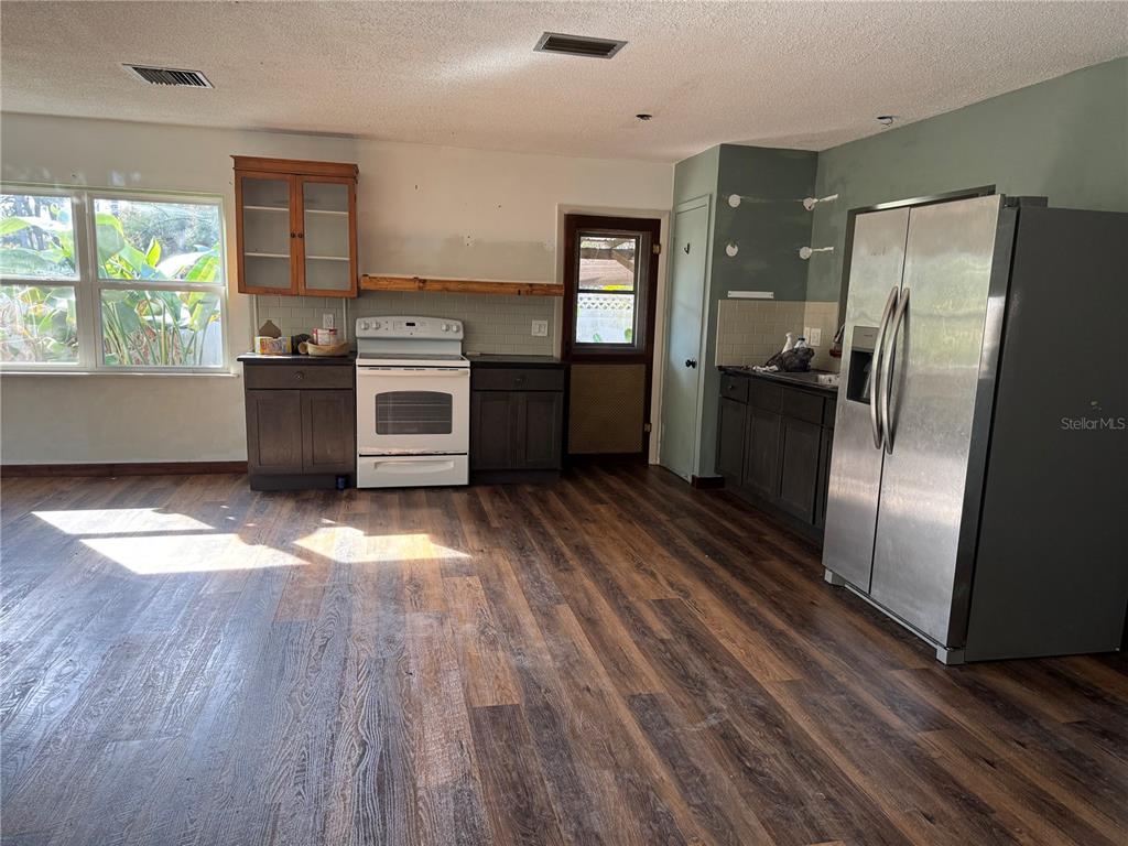 861 Palermo Road St. Augustine, FL 32086 - Photo 8 of 33 a kitchen with stainless steel appliances a refrigerator sink and wooden floor