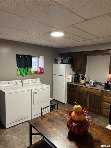 a kitchen with a refrigerator and a stove top oven