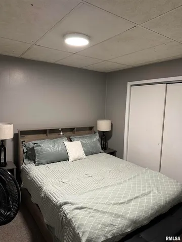 a bedroom with a bed and a night stand