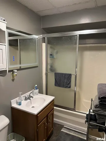 a bathroom with a sink toilet and mirror