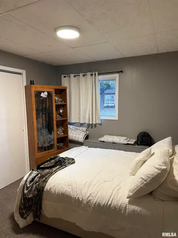 a bedroom with a bed and window