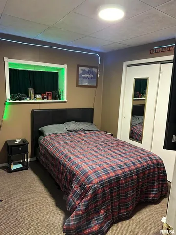 a bedroom with a large bed and a window