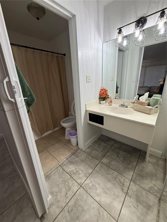 43420 Highway 27, Unit 150 Davenport, FL 33837 - Photo 5 of 8 a bathroom with a sink a toilet and a mirror