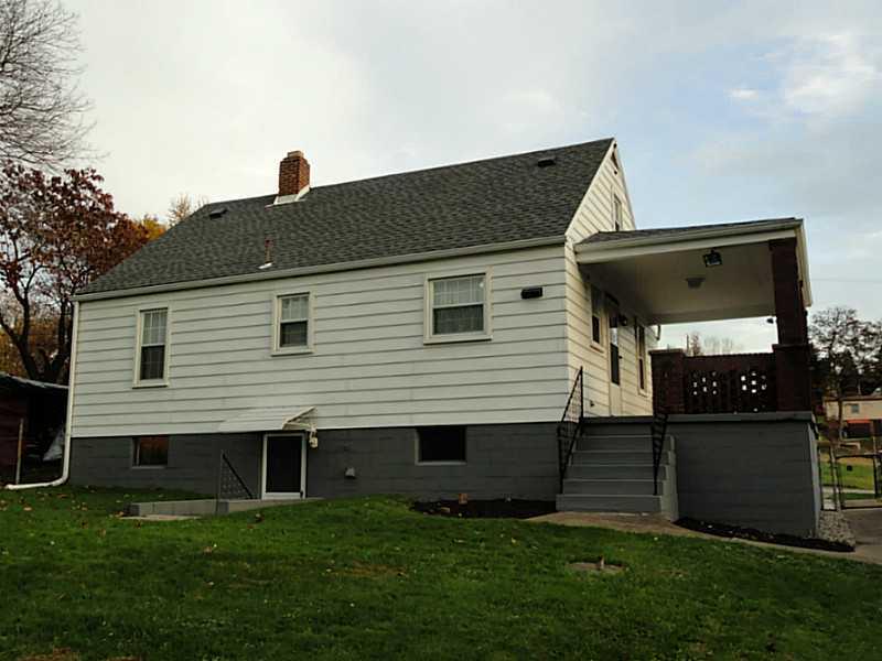 4015 Chieftan Road Irwin, PA 15642 - Photo 22 of 24 Exterior Back. The back yard is accessible from the side porch and the basement walk-out.