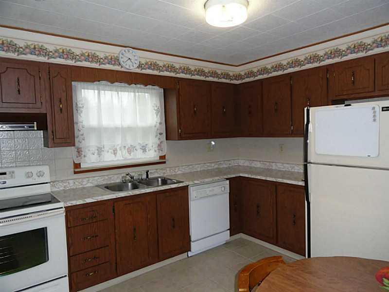 4015 Chieftan Road Irwin, PA 15642 - Photo 6 of 24 Kitchen. The kitchen includes newer electric stove, a dishwasher and refrigerator.