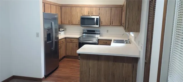 a kitchen with granite countertop a sink a stove and cabinets