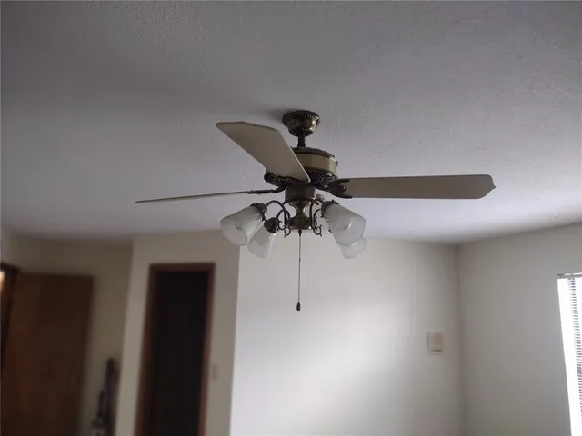 a utility room with a stove top oven and next to a window