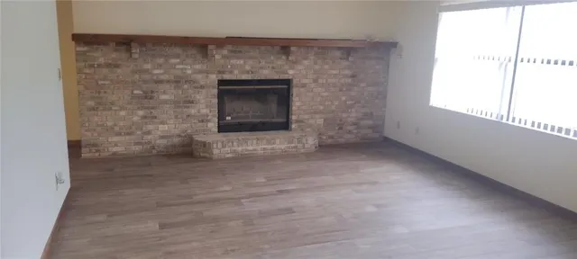a view of empty room with a fireplace