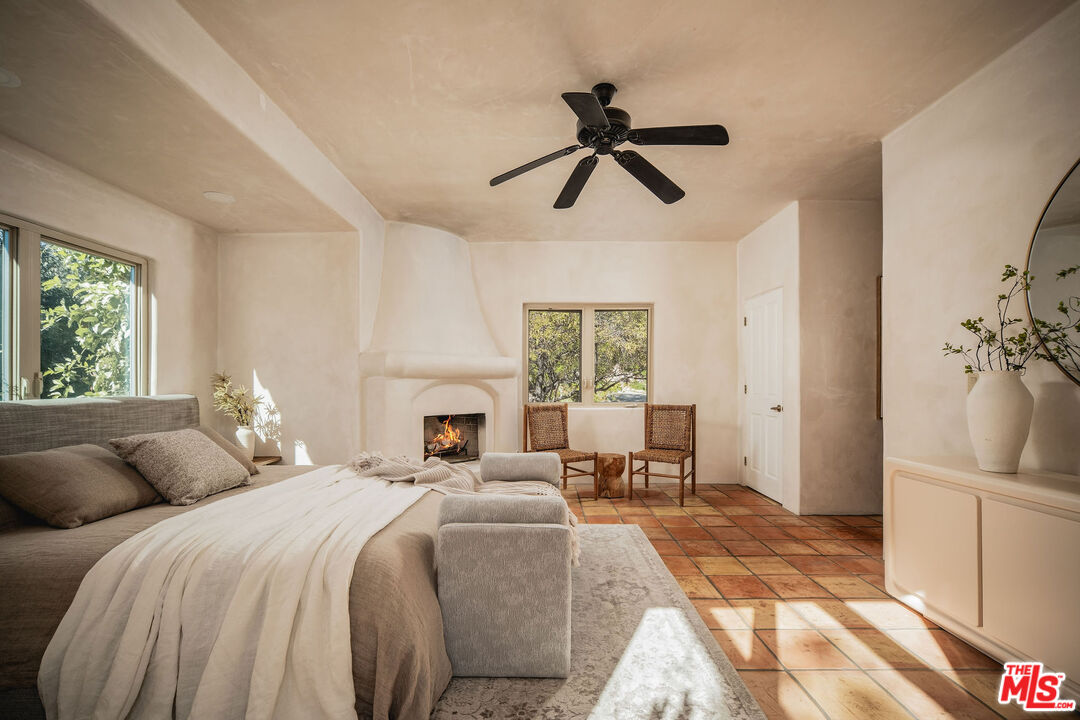 3450 Thacher Road Ojai, CA 93023 - Photo 12 of 33 a spacious bedroom with a large bed and a chandelier