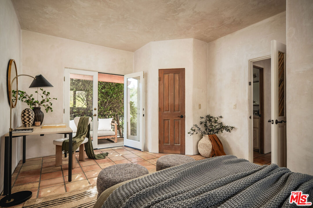3450 Thacher Road Ojai, CA 93023 - Photo 15 of 33 a bedroom with furniture and a potted plant