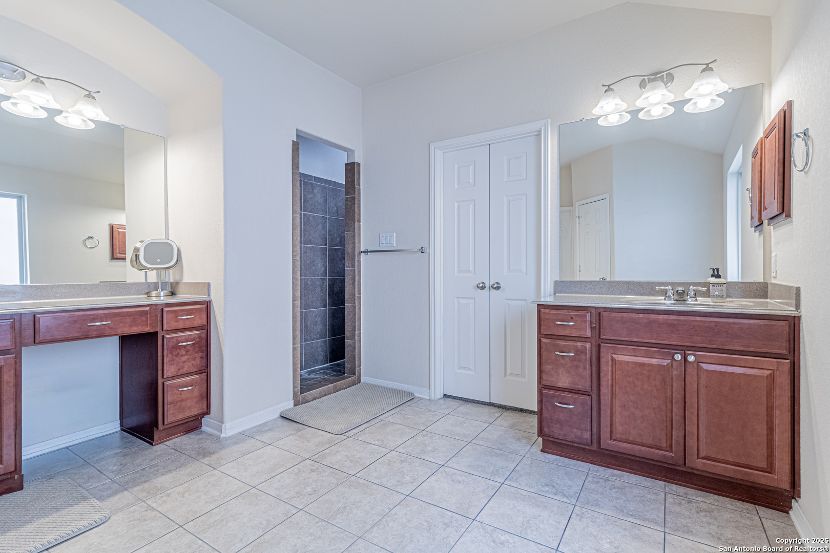 159 Brook View Cibolo, TX 78108 - Photo 16 of 24 a spacious bathroom with a granite countertop sink and a mirror